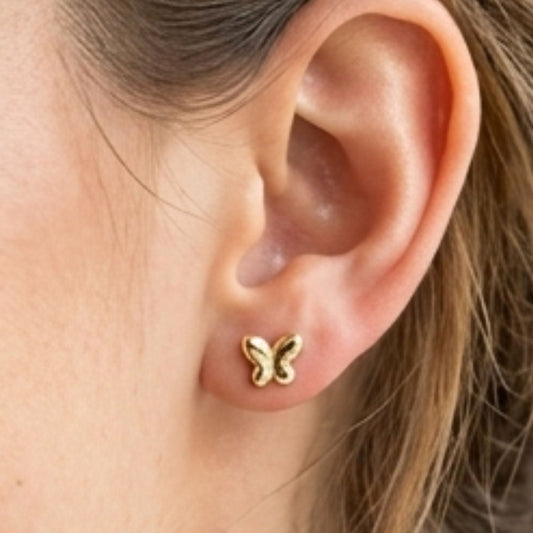 Chica luciendo Pendientes de plata baño de oro dorados diseño de joyería Osnor mariposa minimalista