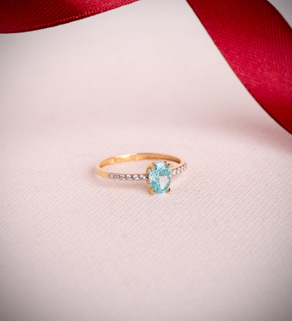 18K SORTIJA ORO BICOLOR TOPACIO NATURAL PARAIBA OVAL 7X5MM 0,93 QTS. Y CIRCONITAS
