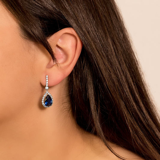 18K PENDIENTES ORO BLANCO DOS CUERPOS CON PIEDRA AZUL 12 X 8MM. 33X12MM CIERRE PRESION