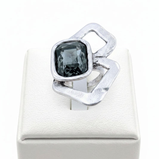 Anillo Zamak con circonita gris cushion-cut  sobre expositor de madera, Joyería Osnor Zamak