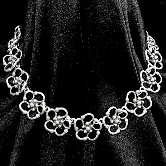 expositor luciendo collar flor zamak mujer exclusivo joyeria osnor zamak