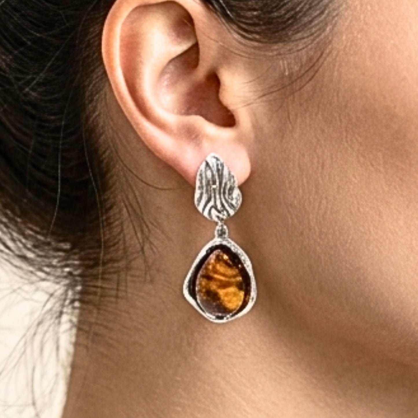 Chica luciendo Pendientes acero inoxidable plateado mujer diseño joyería osnor moda moderno elegante boda fiesta glamour lujo 